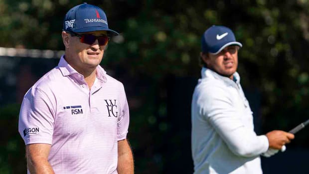 Zach Johnson (left) watches Brooks Koepka (right) tee shot on the fifth hole during a practice round at the 2023 British Open.
